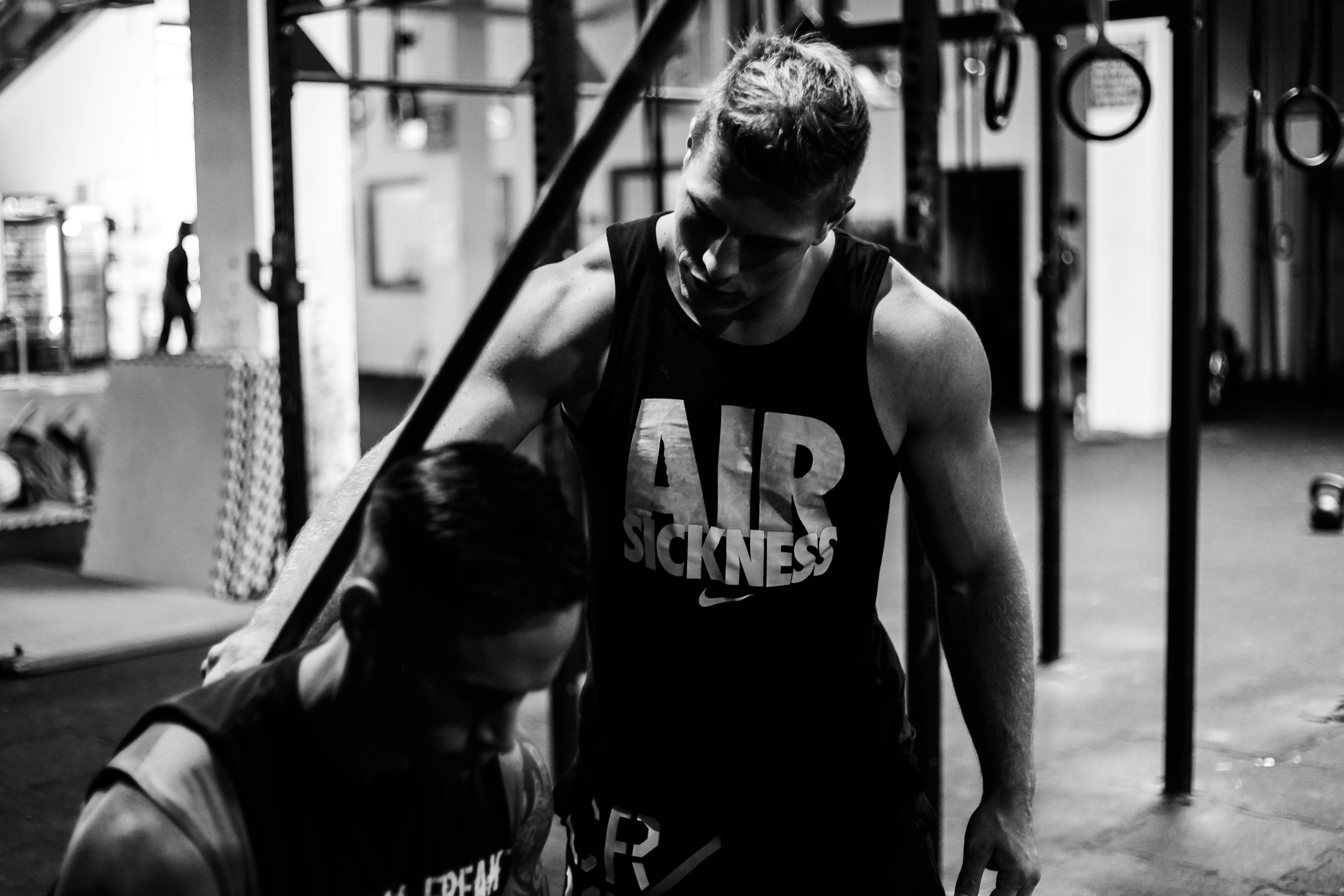 A personal trainer cueing a client through a barbell movement.